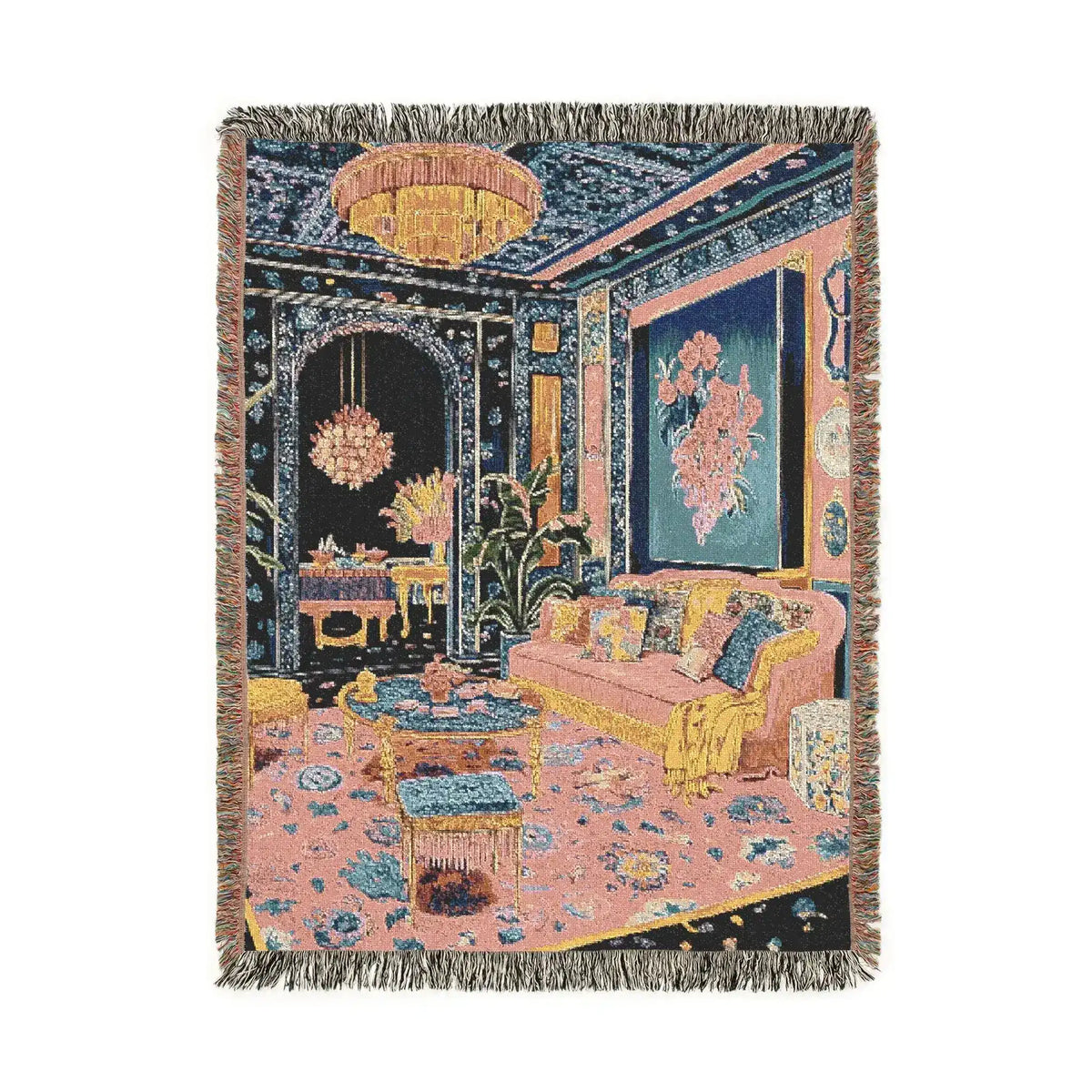 Portrait fringed woven throw showing opulent room with chandelier floral walls pink sofa and patterned carpet in navy and pink on the Maximalist Dreamscape Woven Blanket
