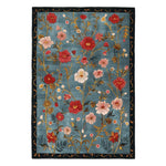 The Meadow Muse Hand Tufted Area Rug features a vibrant floral design on a soft blue background. This wool rug is perfect for adding a touch of vintage elegance to any living room, with its intricate detailing and warm, inviting colors. Ideal for those seeking high-quality area rugs for living room spaces, this rug combines style and comfort effortlessly.
