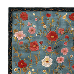 The Meadow Muse Hand Tufted Rug showcases a vibrant floral pattern on a rich blue background, capturing the essence of a vintage rug. This area rug, crafted from quality wool, is ideal for adding a touch of elegance to your living room. The intricate design and vivid colors make it a standout piece among rugs for living rooms.