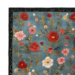 The Meadow Muse Hand Tufted Rug showcases a vibrant floral pattern on a rich blue background, capturing the essence of a vintage rug. This area rug, crafted from quality wool, is ideal for adding a touch of elegance to your living room. The intricate design and vivid colors make it a standout piece among rugs for living rooms.