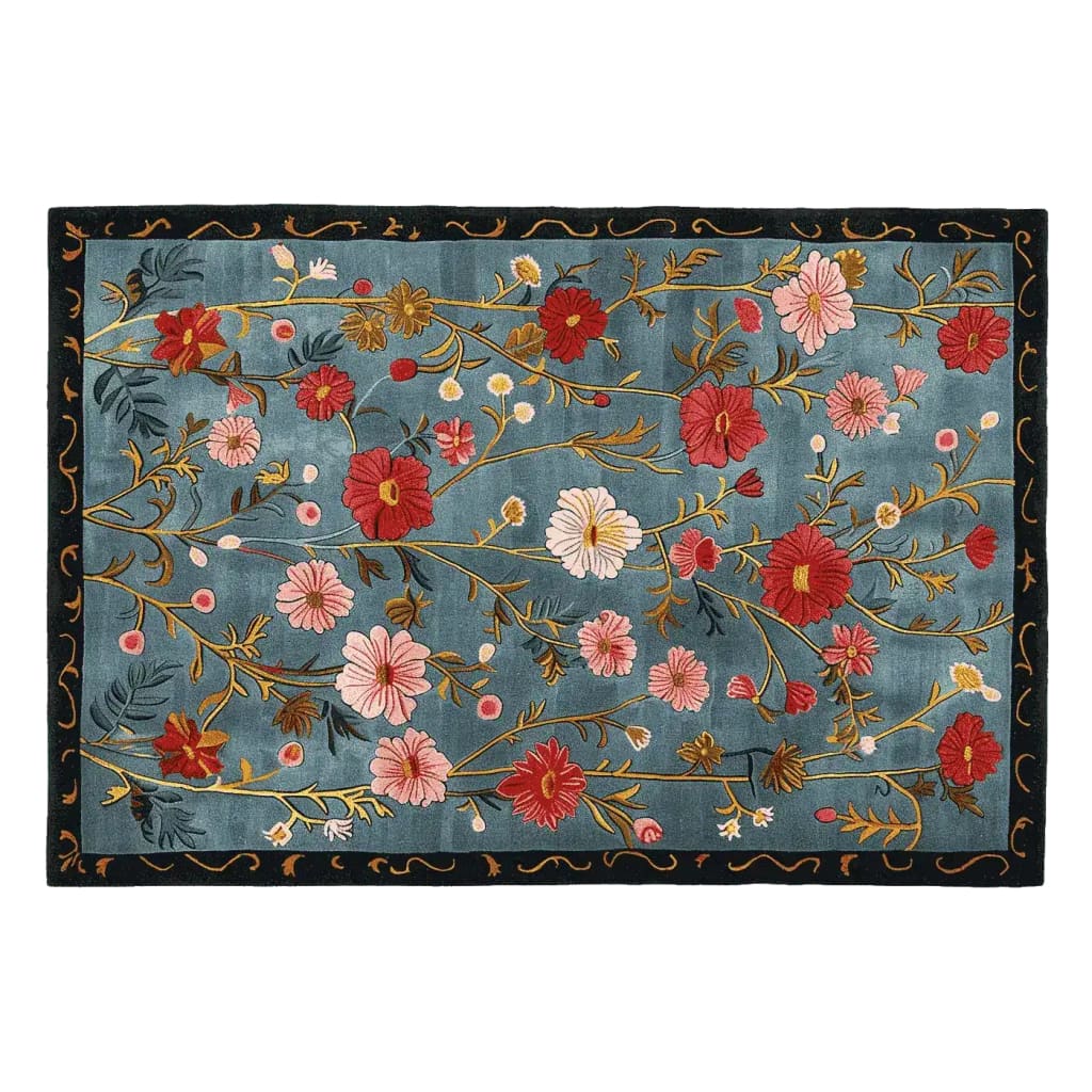 The Meadow Muse Hand Tufted Rug is a stunning area rug featuring a vibrant floral pattern with red and pink blooms on a rich blue background. This wool rug is perfect for adding a vintage touch to living rooms, making it an ideal choice for those seeking beautiful area rugs for living room decor.