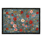 The Meadow Muse Hand Tufted Rug is a stunning area rug featuring a vibrant floral pattern with red and pink blooms on a rich blue background. This wool rug is perfect for adding a vintage touch to living rooms, making it an ideal choice for those seeking beautiful area rugs for living room decor.