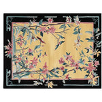A beautifully hand-tufted area rug featuring an intricate floral design with birds. The rug showcases a vibrant mix of pink and green hues set against a warm yellow backdrop, bordered by a contrasting black frame. Ideal as a wool rug for the living room, this elegant 8x10 rug adds a touch of nature-inspired charm to any space.