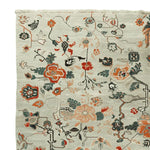 A detailed view of the Meandering Floral Vines Hand Knotted Area Rug, showcasing intricate floral patterns in vibrant colors. Perfect as a wool rug for living rooms, this 8x10 floral rug adds elegance and warmth to any space.