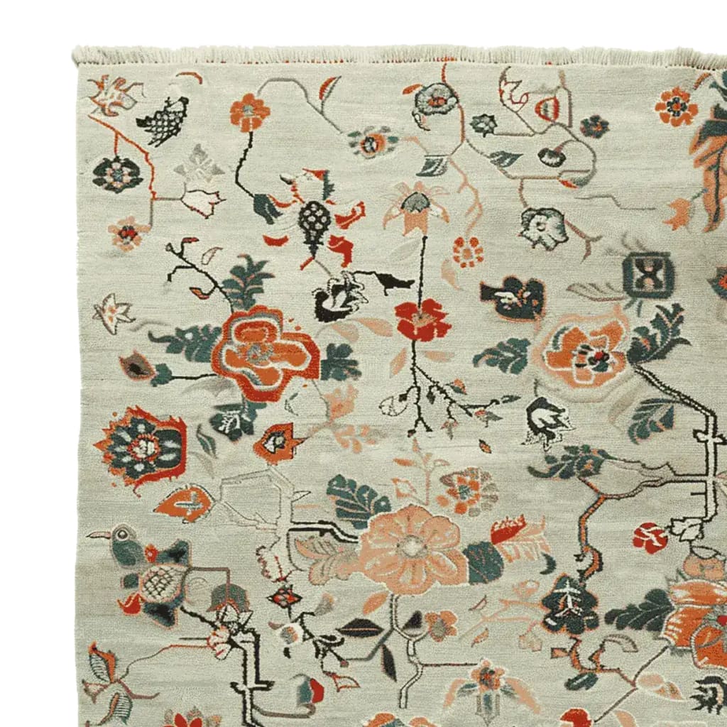 A detailed view of the Meandering Floral Vines Hand Knotted Area Rug, showcasing intricate floral patterns in vibrant colors. Perfect as a wool rug for living rooms, this 8x10 floral rug adds elegance and warmth to any space.