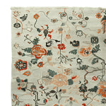 A detailed view of the Meandering Floral Vines Hand Knotted Area Rug, showcasing intricate floral patterns in vibrant colors. Perfect as a wool rug for living rooms, this 8x10 floral rug adds elegance and warmth to any space.