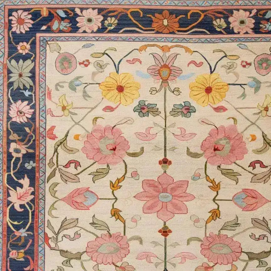 This image showcases a Medallion Bloom Hand Knotted Area Rug, featuring a beautiful floral pattern with vibrant pink, yellow, and blue flowers. The intricate border design evokes a vintage Persian rug style, making it perfect for large living rooms. This elegant floral rug is an exquisite addition to any space, enhancing the aesthetic of rugs for living room decor.