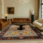 Elegant large living room featuring a Medallion Bloom Hand Knotted Area Rug with intricate floral patterns. This vintage Persian rug adds a touch of sophistication to the space, perfectly complementing the classic style of the brown leather sofas and round wooden coffee table.