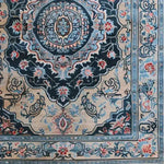 A detailed view of a Medallion Hand Tufted Area Rug, showcasing its intricate vintage Persian design. Perfect for dining rooms, large living rooms, or as a classic wool rug under a dining table, this elegant piece features ornate floral patterns and a rich color palette that adds sophistication to any living space.