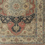 A beautifully intricate Medallion Majesty Hand Knotted Area Rug, showcasing a vintage Persian design with floral patterns in rich reds, blues, and creams. This wool rug is perfect for adding elegance to living room spaces, ideally sized for an 8x10 area.