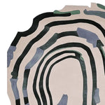 Top view of the 'Meltdown in Motion' hand tufted area rug, showcasing an abstract design with bold, flowing black and blue stripes against a soft beige background. This contemporary wool rug offers a unique aesthetic, perfect for adding a modern touch to living rooms. Ideal for spaces requiring an 8x10 size rug.