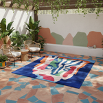 Colorful abstract rug on a patterned patio with chairs and plants