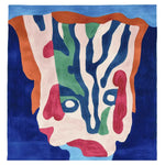 Colorful abstract rug on a patterned patio with chairs and plants