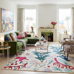 Modern living room with a colorful rug, green sofa, and decorative elements.