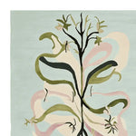 A beautifully crafted area rug showcasing an abstract floral design in shades of green and pink on a soft blue background. This wool rug is perfect for adding a touch of elegance to large living rooms, making it a standout piece among area rugs for living room decor.