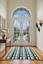 Decorative French doors with intricate ironwork, rug, in a home interior.