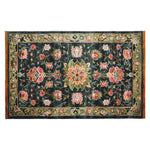Top view of the Midnight Bloom Mosaic Hand Tufted Area Rug, showcasing a vibrant floral design with pink and green patterns on a dark background. This wool rug is perfect for large living rooms, adding a touch of elegance to any space.