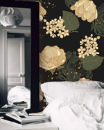 Midnight blooms floral wallpaper in bedroom with white bedding and leaning floor mirror