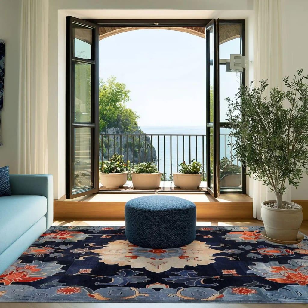 The Midnight Blossom Tapestry Hand Tufted Area Rug is beautifully displayed in a bright living room setting. This elegant 8x10 floral rug features vintage charm with bold, vibrant colors, making it an ideal choice for both living room and office spaces. Made from high-quality wool, this rug perfectly complements the cozy, serene ambiance with an open view of nature outside.