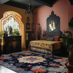 Beautifully styled vintage rug in a cozy living room setting, featuring the Midnight Blossom Tapestry Hand Tufted Area Rug. This wool rug showcases an intricate floral design in rich blues and vibrant orange, perfect for adding warmth to any living room or office. Ideal as an 8x10 rug, it complements traditional and modern decor alike.