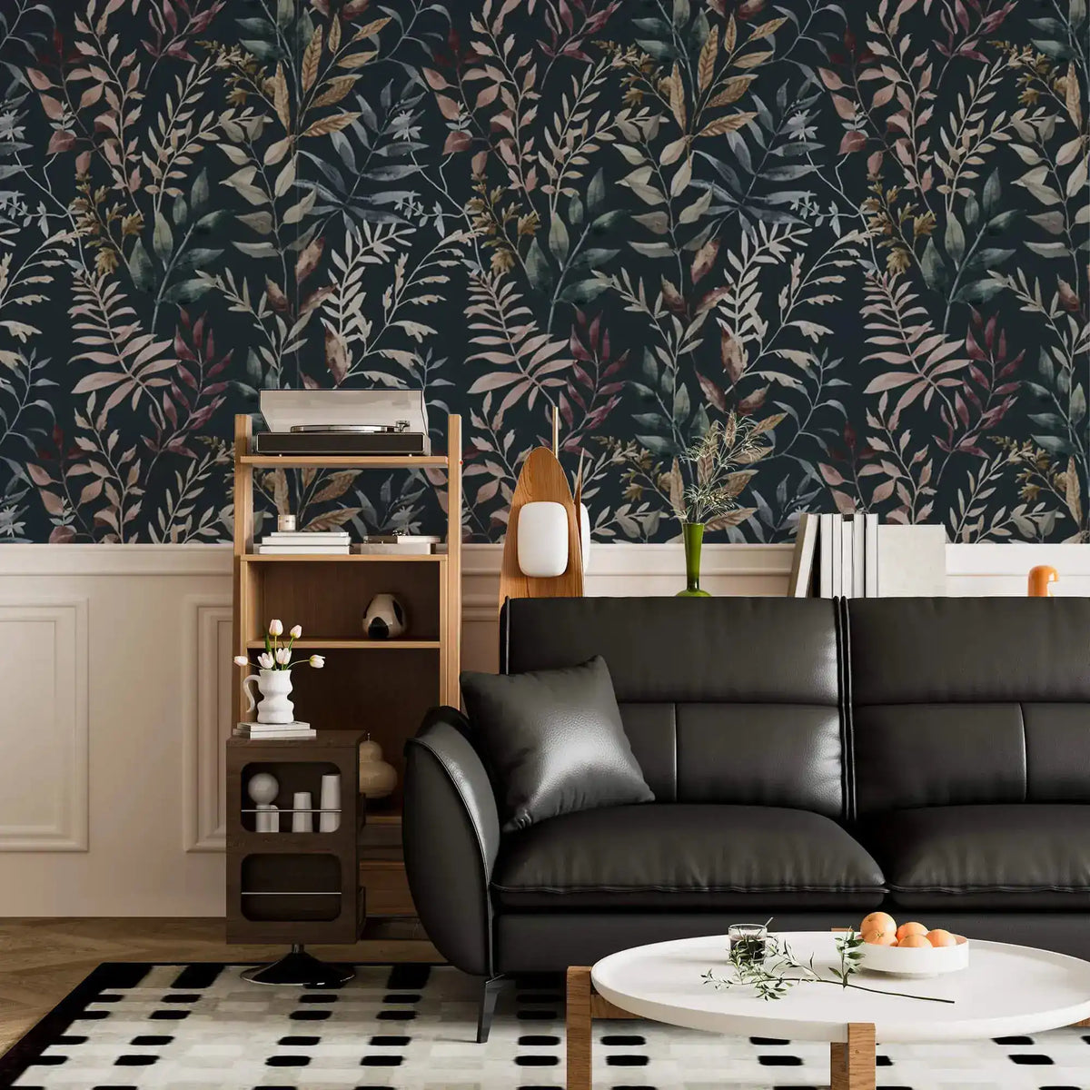 Midnight botanical wallpaper above white wainscoting with black leather sofa, white coffee table, and open shelving unit.