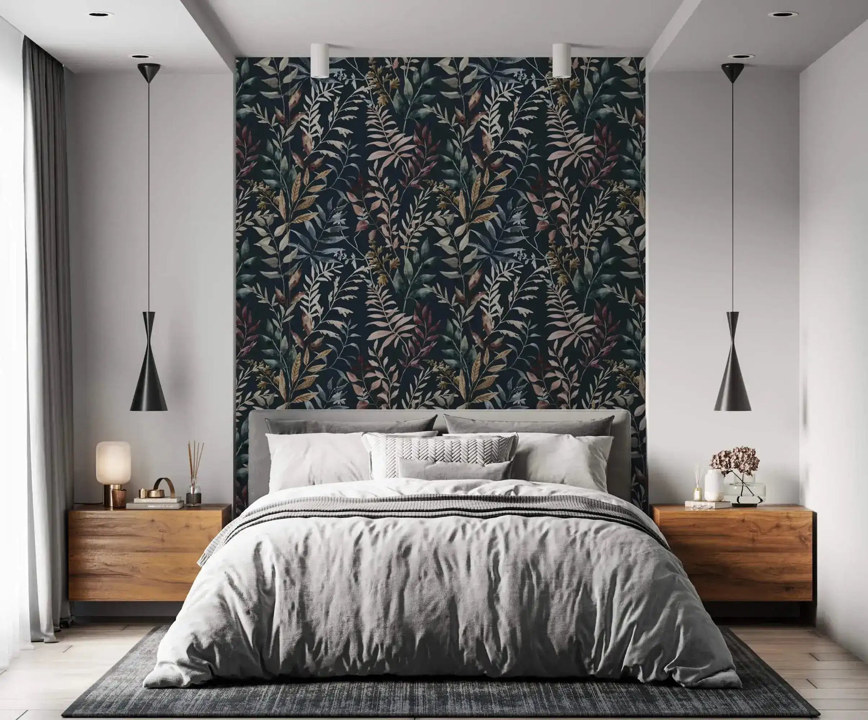 Midnight botanical wallpaper feature wall behind gray upholstered bed with walnut nightstands and black pendant lights.