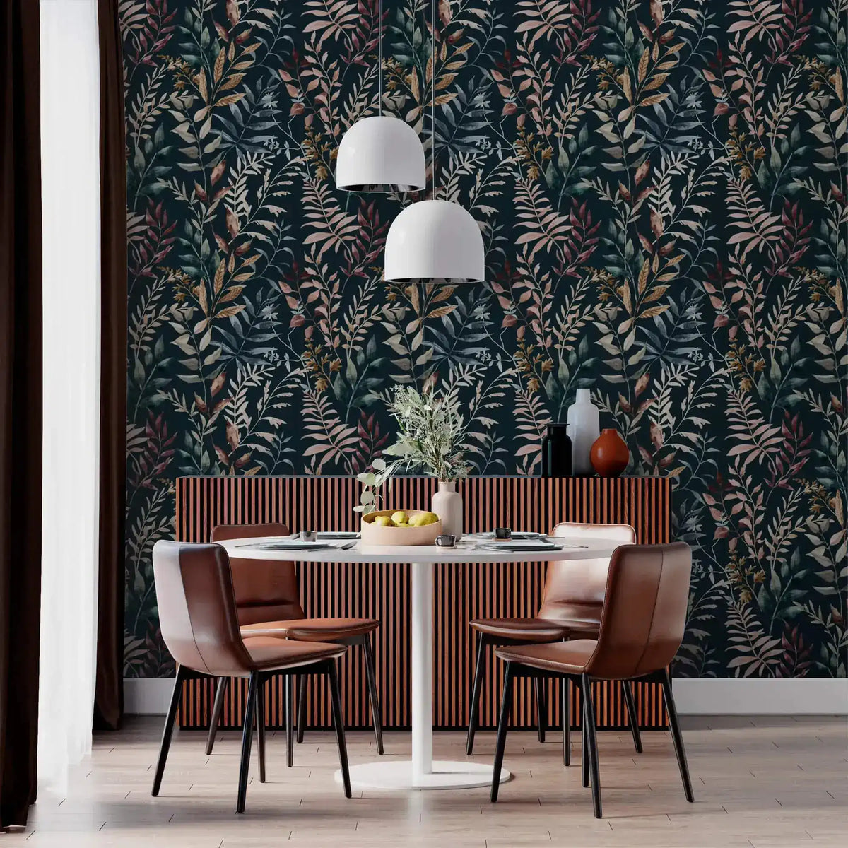 Midnight botanical wallpaper with dark leaf pattern in dining room with brown leather chairs and white pendant lights.
