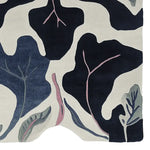 Top view of the Midnight Leaf Veins Hand Tufted Area Rug, showcasing its contemporary abstract design with bold black and blue leaf patterns on a cream background. This wool rug is perfect for adding a modern touch to living rooms, especially as a centerpiece among living room rugs 8x10.