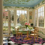 A vibrant and stylish area rug enhances a sunlit living room, showcasing a mix of modern and vintage design. This wool rug, perfect for an 8x10 living room setup, features intricate patterns that add elegance and warmth to the space.