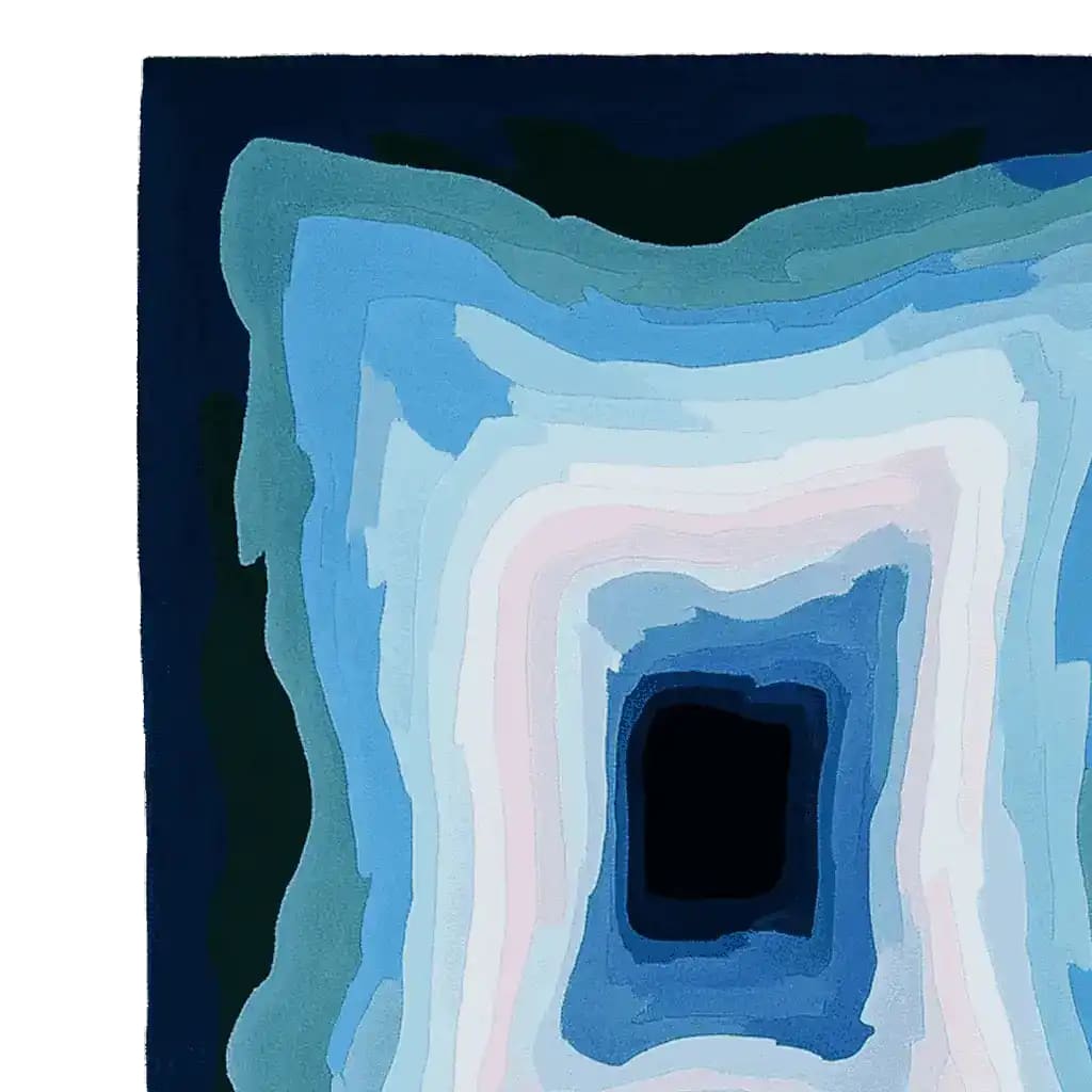 Top view of the Midnight Mirage Layers Hand Tufted Rug showcasing a striking abstract design with layered shades of blue and white. This contemporary area rug, crafted from high-quality wool, is an 8x10 large living room rug perfect for adding modern elegance to any space.
