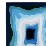 Top view of the Midnight Mirage Layers Hand Tufted Rug showcasing a striking abstract design with layered shades of blue and white. This contemporary area rug, crafted from high-quality wool, is an 8x10 large living room rug perfect for adding modern elegance to any space.