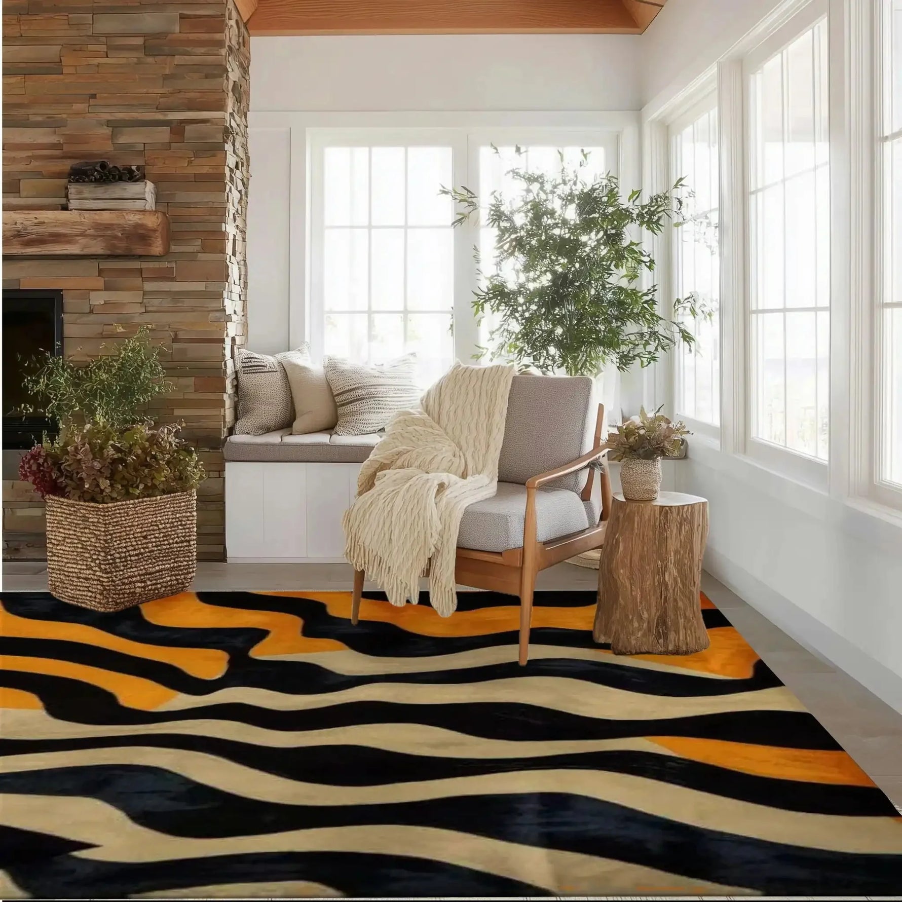 A contemporary wool area rug with an abstract tiger stripe pattern in black, orange, and beige, placed in a cozy living room. The room features a comfortable armchair, a rustic wooden side table, and a basket with greenery, complemented by a stone fireplace and large windows, creating a warm and inviting atmosphere. Ideal for adding a touch of style to large living room spaces.