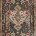 Close-up of a Midnight Mosaic Hand Knotted Area Rug featuring intricate Persian designs with floral patterns in rich reds and earthy browns on a dark background. Perfect for vintage-inspired living room decor, this 8x10 rug adds elegance and charm.