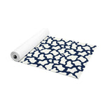 Partially rolled navy and white mosaic yoga mat angled to show its full patterned surface