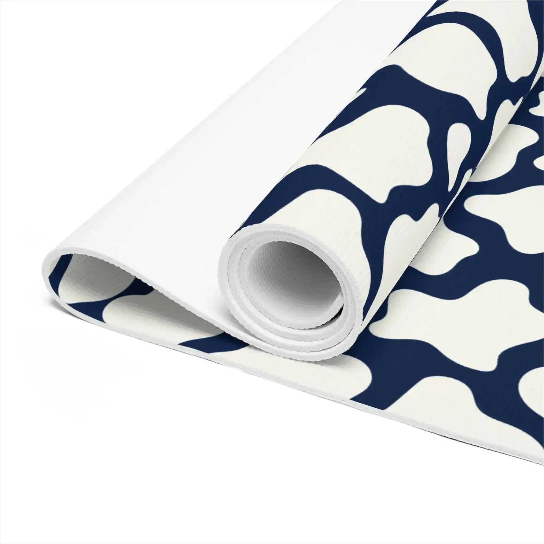 Close-up of the rolled yoga mat revealing its white underside and navy mosaic top