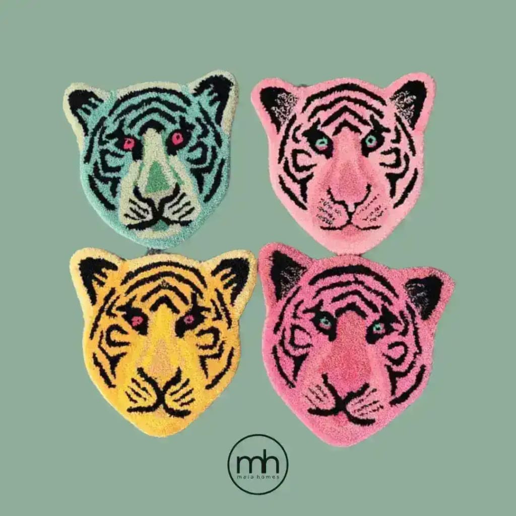 A vibrant collection of hand-tufted wool area rugs in the shape of tiger faces, featuring bold colors like blue, pink, yellow, and peach. Perfect for adding a playful touch to your office or living room, these accent rugs bring a unique and artistic flair to any space.
