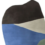 Top view of a Minimal Mood hand tufted area rug featuring an abstract design with bold color blocks of black, blue, beige, and green. This contemporary wool rug is perfect for adding a modern touch to living room spaces, making it an ideal choice for those seeking stylish area rugs for living room decor.