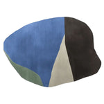 A contemporary hand-tufted area rug with an abstract design featuring blue, green, beige, and black shapes. This wool rug is perfect for adding a modern touch to any living room space.