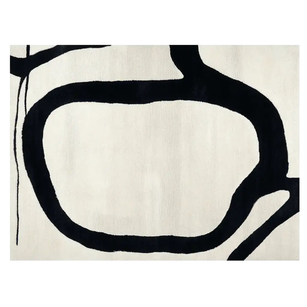 Top view of a contemporary area rug featuring an abstract black pattern on a white background. This wool rug is perfect for adding a modern touch to any living room.