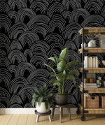 Minimalist Midnight Lines wallpaper, white sketched arch waves on black behind plants and shelf