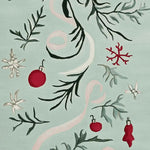 A close-up view of the Mistletoe Ribbon Dance Hand Tufted Area Rug, featuring a festive design with red ornaments and green foliage on a soft background. This wool rug is ideal for adding a touch of holiday charm to living room area rugs, perfect for cozy gatherings. A beautiful choice among area rugs for living room settings.