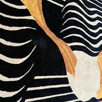 Close-up view of the Mocha Mirage Hand-Tufted Area Rug showcasing its bold abstract design with black, white, and gold stripes. This contemporary wool rug is perfect for adding a stylish touch to any dining room, serving as an elegant large area rug that enhances formal dining room settings.