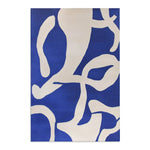 Modern Abstract Blue & White Rug side view under warm lighting — fiber texture and navy pile loops highlighted along side edge