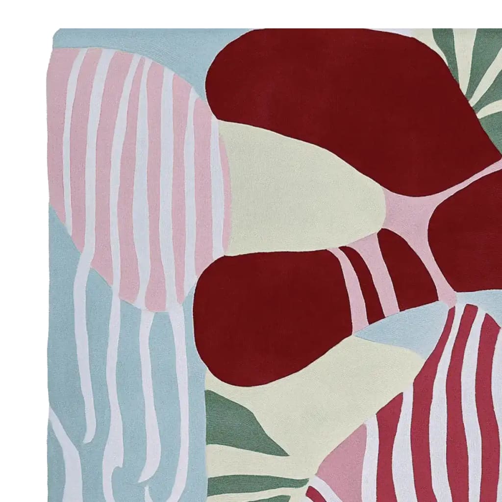 Vibrant and modern color collision hand tufted area rug featuring abstract patterns in red, pink, and green. This contemporary wool rug adds a stylish touch to any living room decor.