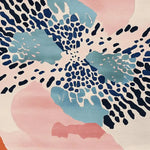 A vibrant Modern Drama Hand Tufted Rug featuring an abstract design in blue, pink, and beige tones. This contemporary wool rug adds a stylish touch to any living room area. Perfect as a living room area rug, it fits well in an 8x10 space.