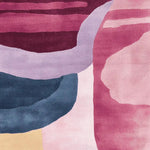 A vibrant area rug with a modern fluid form design, showcasing rich shades of pink, purple, and blue. This contemporary wool rug is perfect for adding a splash of color to any living room, making it an ideal choice for large living room rugs.