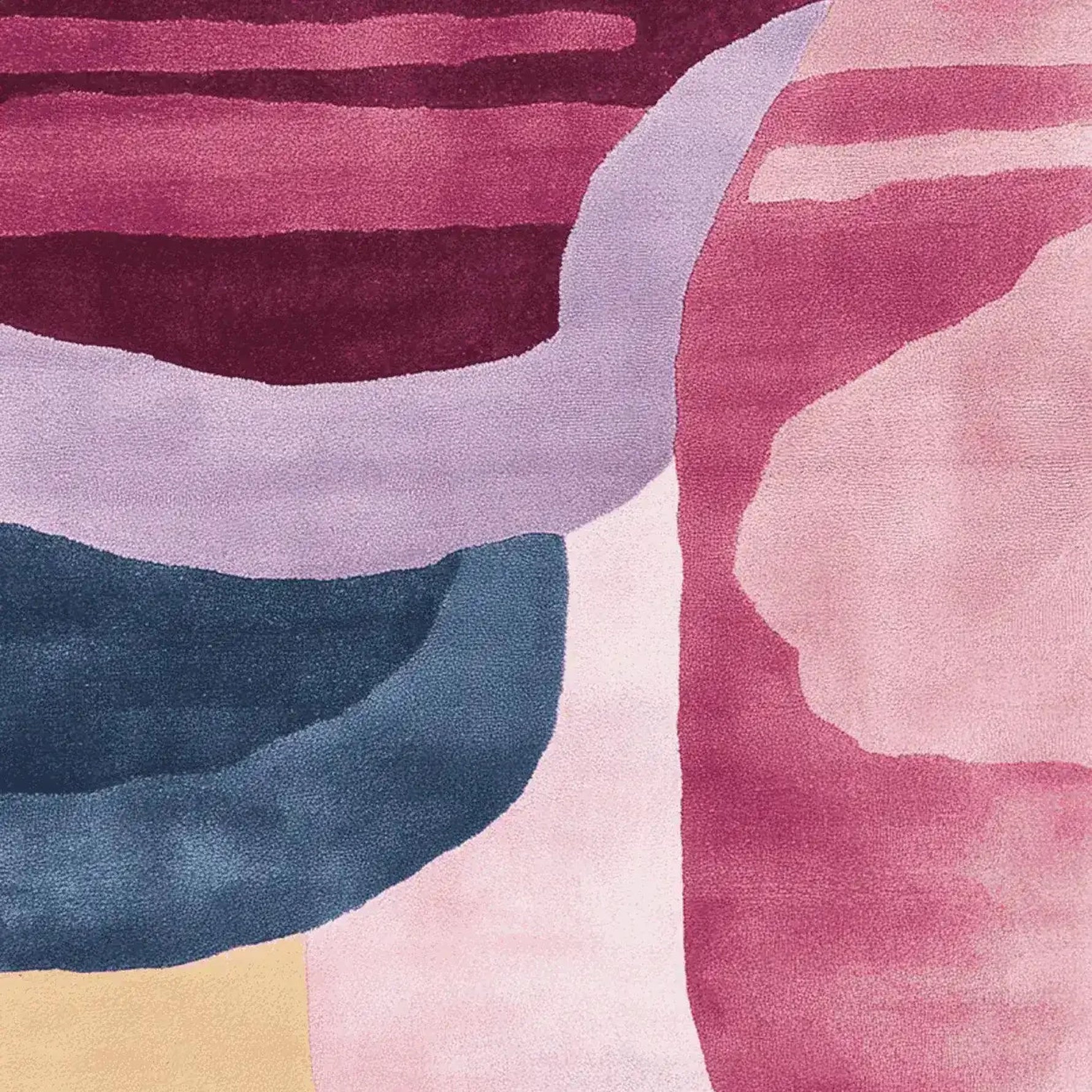 A vibrant area rug with a modern fluid form design, showcasing rich shades of pink, purple, and blue. This contemporary wool rug is perfect for adding a splash of color to any living room, making it an ideal choice for large living room rugs.