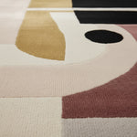 Close-up of a geometric-patterned rug with various colors.