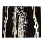 Top view of a Modern Heat Stroke Hand Tufted Area Rug featuring an abstract design in black and white stripes. This contemporary wool rug is perfect for adding a stylish touch to living room spaces, available in an 8x10 size.