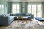 Living room with a gray sectional sofa, floral rug, and decorative elements.